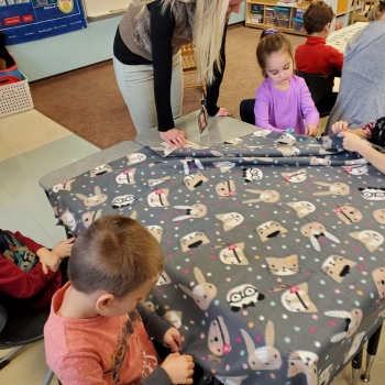 Students making blankets for My Very Own Blanket Organization.